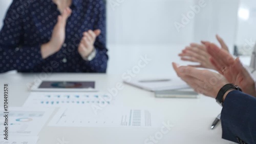 Business people applauding after successful presentation during a meeting in the office, showing good teamwork with positive attitude. Handshake concept