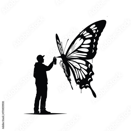 Silhouette of artist spray painting a giant butterfly mural black and white graffiti art
