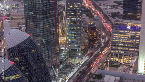 Skyline of the buildings of Sheikh Zayed Road and DIFC aerial day to night timelapse in Dubai, UAE.