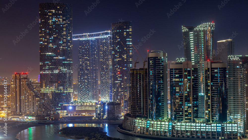 Fototapeta premium Buildings on Al Reem island in Abu Dhabi day to night timelapse from above.