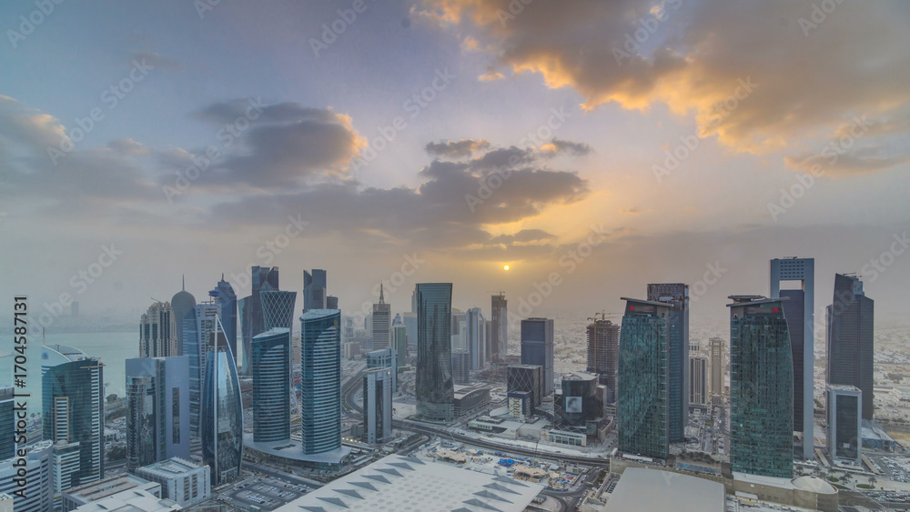 Fototapeta premium Skyscrapers at sunset timelapse in the skyline of commercial center of Doha, the capital Qatar