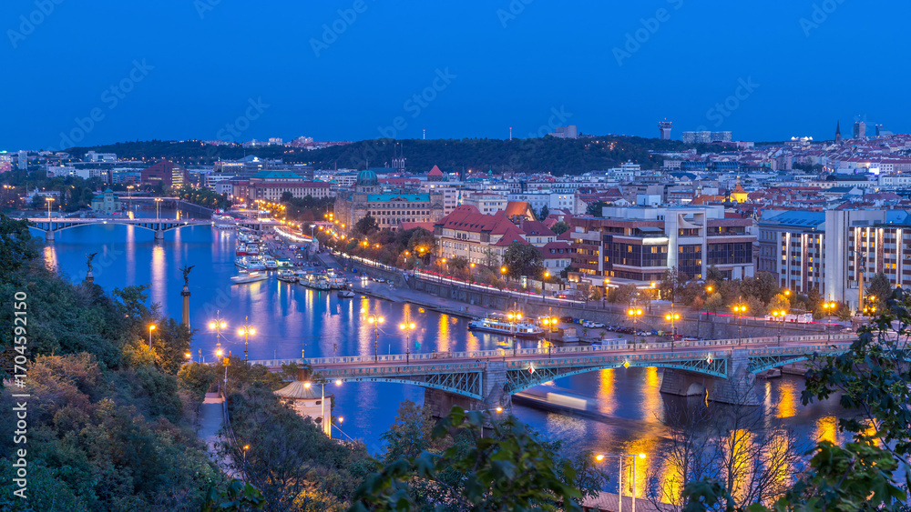 Fototapeta premium Aerial evening view of the Vltava River and illuminated bridges day to night timelapse, Prague
