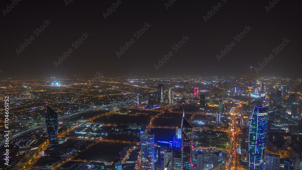 Fototapeta premium Skyline with Skyscrapers night timelapse in Kuwait City downtown illuminated at dusk. Kuwait City, Middle East