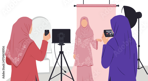 Female Muslim Model Posing In Pink Dress While Being Photographed In Photography Studio With Digital Cameras