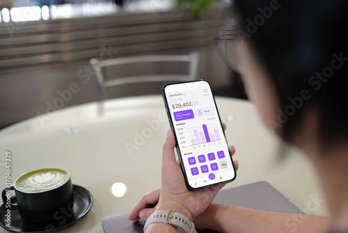 A person reviewing their financial balance and statistics on a mobile banking or investment app dashboard, showcasing personal finance management.