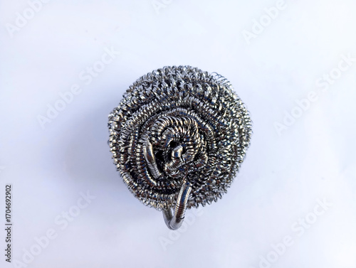 Metal scrubber used for cleaning kitchen utensils isolated on white background.