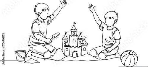 Two happy children building a sandcastle on the beach with a ball nearby