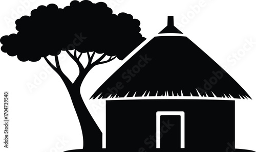 Traditional thatched roof hut nestled beneath a large acacia tree in a rural landscape.