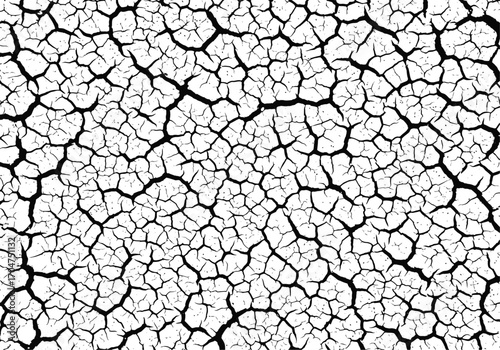 Abstract close up of cracked dry earth surface texture with intricate geometric patterns and dark fissures