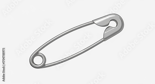 A silver safety pin is shown in a close up studio shot of the object