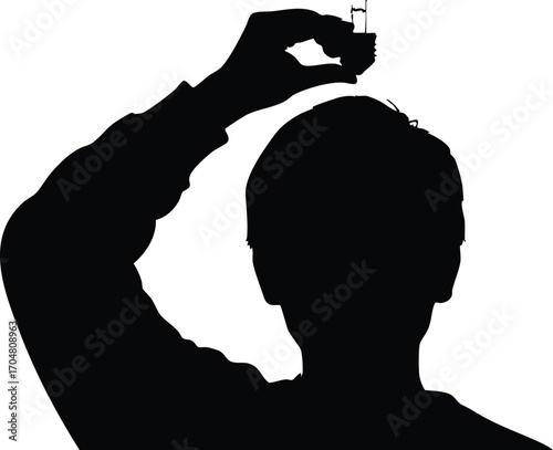 Silhouette of a person holding a small object, creating a mysterious and intriguing image, suitable for concepts like decision, choice, or control