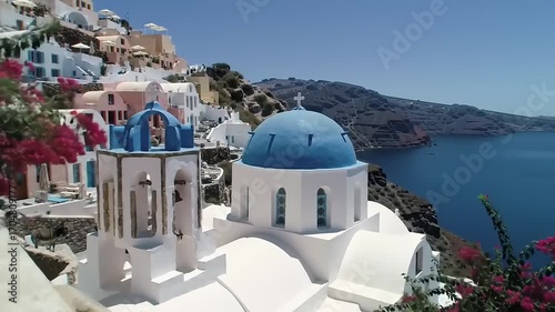 White buildings with blue domes and bell tower on sunny day