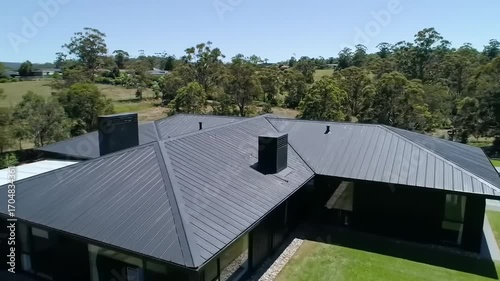 Wallpaper Mural Modern house with dark metal roof and swimming pool Torontodigital.ca