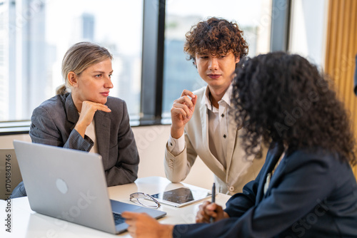 Diverse tech team meeting on software project, mentor guiding coworker on laptop, teamwork development using collaboration tools, modern technology, app design, dev training and enterprise SaaS team