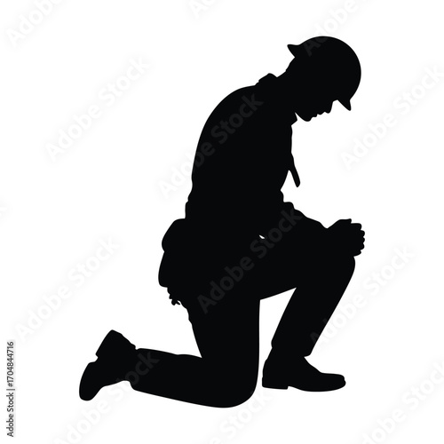 Silhouette of a soldier kneeling in prayer or contemplation on a white background