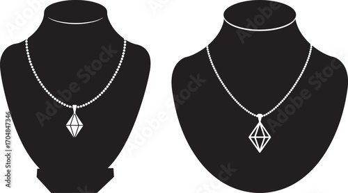Two elegant necklaces displayed on black jewelry busts silhouette