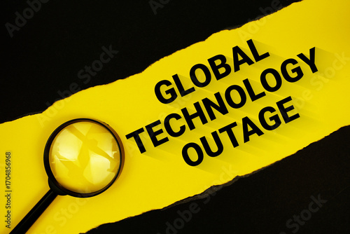 Global Technology Outage text on yellow with black paper torn ripped and magnifying glass