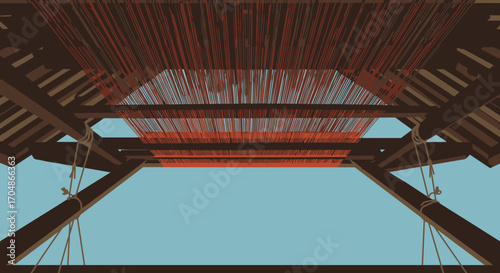 An intricate network of vibrant red threads stretched across a traditional wooden loom, set against a clear blue sky, showcasing the art of weaving.