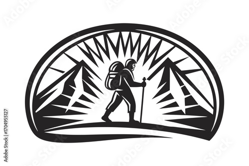 Black and white depicts hiker with backpack walking between mountains using a trekking pole