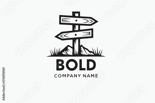 Black directional sign atop mountain design displays a company's name underneath the mountain base