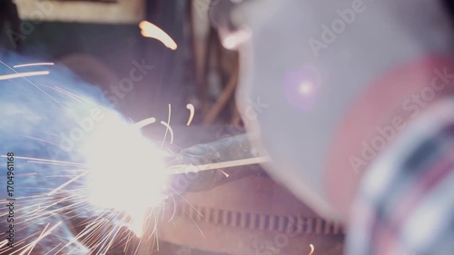 Back View Construction Industrial Factory or Metalwork Concept by Mechanic or Technician Welder Welding Ball Joint Auto Part