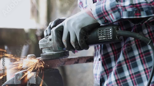 Track Shot Construction Industrial Factory or Metalwork Concept by Mechanic or Technician Using Grinder with Auto Part Workshop