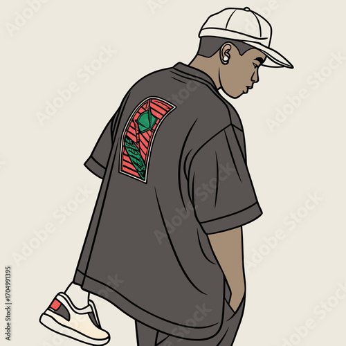 Young man in oversized shirt and baseball cap with graphic design