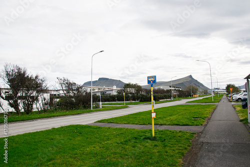 Wallpaper Mural Residential road in Akranes Iceland with a bus stop and mountain view Torontodigital.ca
