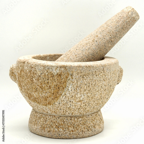 Close-up front view of Angsila a thai traditional granite mortar and pestle photographed from a slightly elevated angle on a plain white background.
