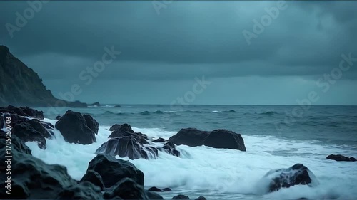 Waves Crashing on Rocky Shoreline Under Dramatic Cloudy Sky