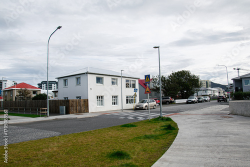 Street view of suburban homes and parked cars in Akranes, Iceland