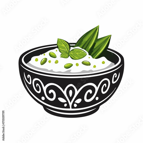 A delicious bowl of white dip garnished with fresh green herbs and seeds, presented in a decorative black bowl with intricate white patterns