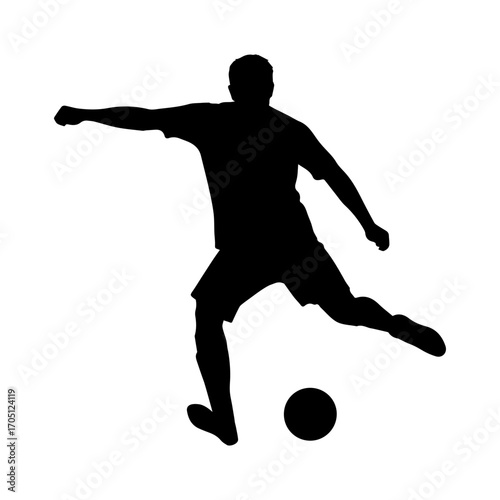 Silhouette of a soccer player kicking a ball