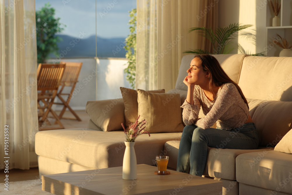 Obraz premium Relaxed woman resting with closed eyes sitting at home