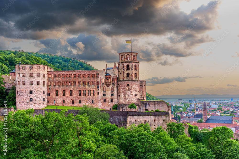 Fototapeta premium Heidelberg Castle At Dusk Surrounded By Lush Greenery And Dramatic Clouds