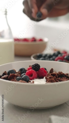 Bowl of cereal, fresh berries, and milk