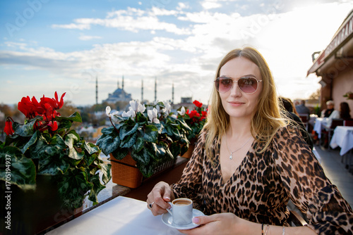 Photography Woman travel in Istanbul and and drink turkey coffee in rooftop cafe near Hagia Sophia famous islamic Landmark mosque, Travel to Istanbul, Turkey background