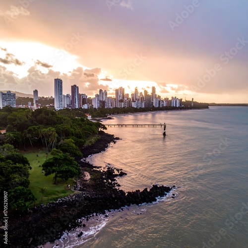 City skyline at sunset over the ocean