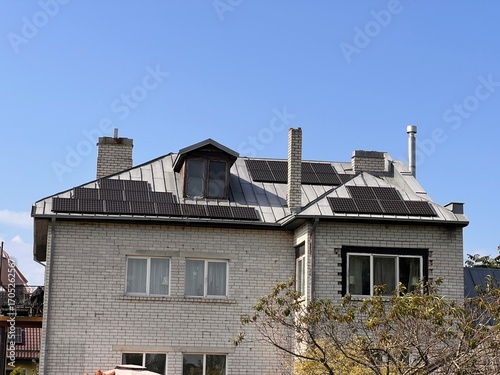 Brick House With Solar Panels on Sunny Day
