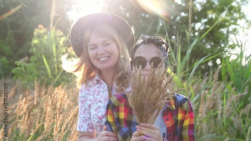 A Mother and Daughter Embracing. A Family Moment in the Sun and meadow. A Family Moment. Mother and Daughter in the Sun with a Nature Background