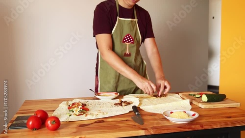 A Modern Chef Preparing a Gourmet Shawarma. A Stylish Chef in a Modern Kitchen. Preparing a Shawarma. Young woman cooking