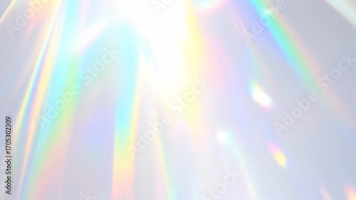 Shimmering prism light flares on a pale grey surface
