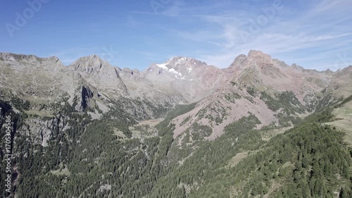 Flying with professional drone above the Scermendone valley, Central Alps of Valtellina, Lombardy