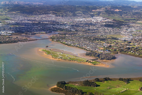 Pararekau Island and Manukau Harbour, Auckland, New Zealand, aerial view. Development in 2025 of gated exclusive subdivision on the island. Motorway, Karaka, Papakura, Takanini and Ardmore in distance