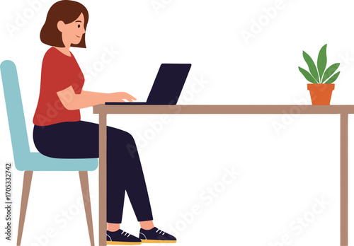 Focused woman working diligently on a laptop at her desk
