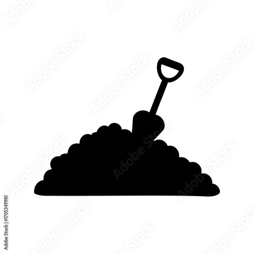Black silhouette of shovel digging into a pile of dirt or soil