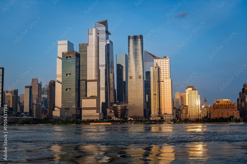 Naklejka premium Hudson Yards skyscrapers with river view in daylight. Tall modern skyscrapers of Hudson Yards seen from across the river in bright daylight.