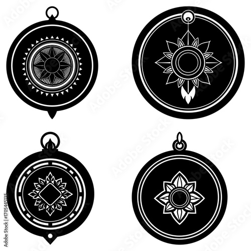Collection of four black and white amulet pendants with floral and geometric designs in a circular frame