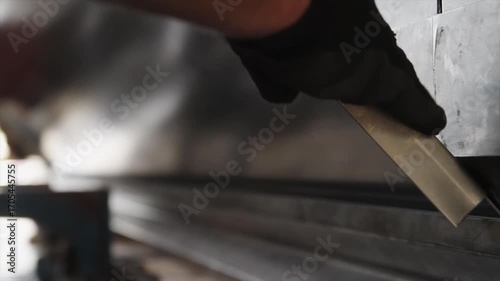 Close-up view of a hydraulic press piston applying force during an industrial pressing process.