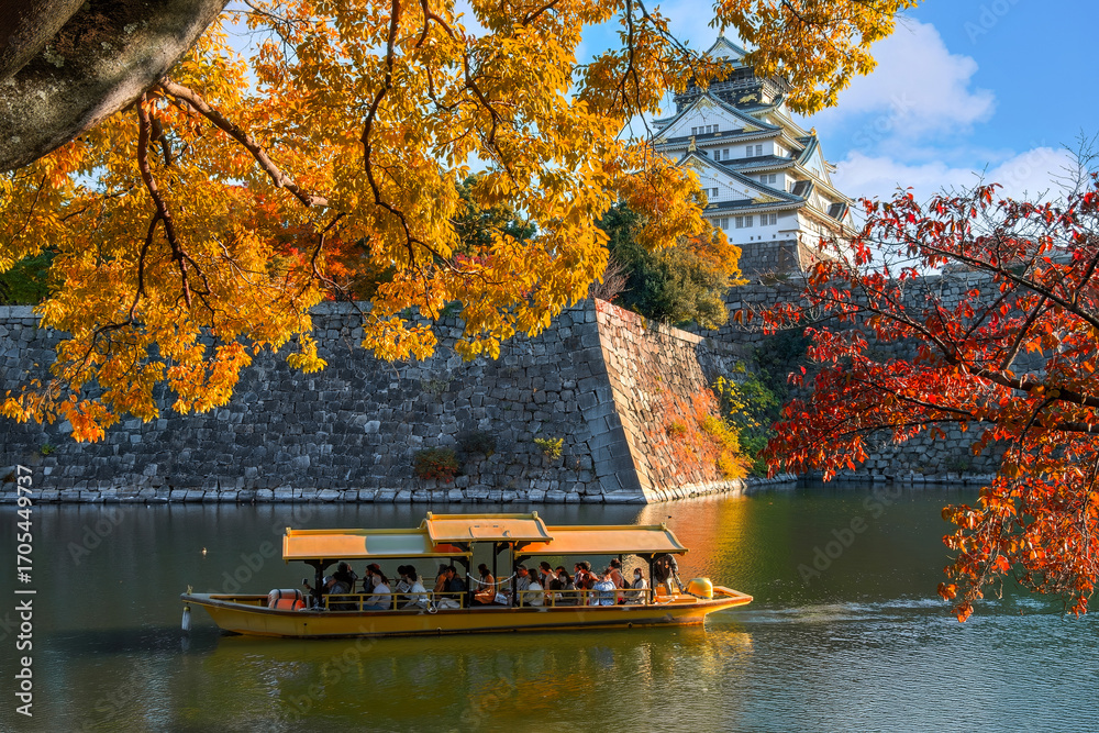 Fototapeta premium Osaka Gozabune boat ride with tourists at the inner moat of Osaka castle in Osaka, japan